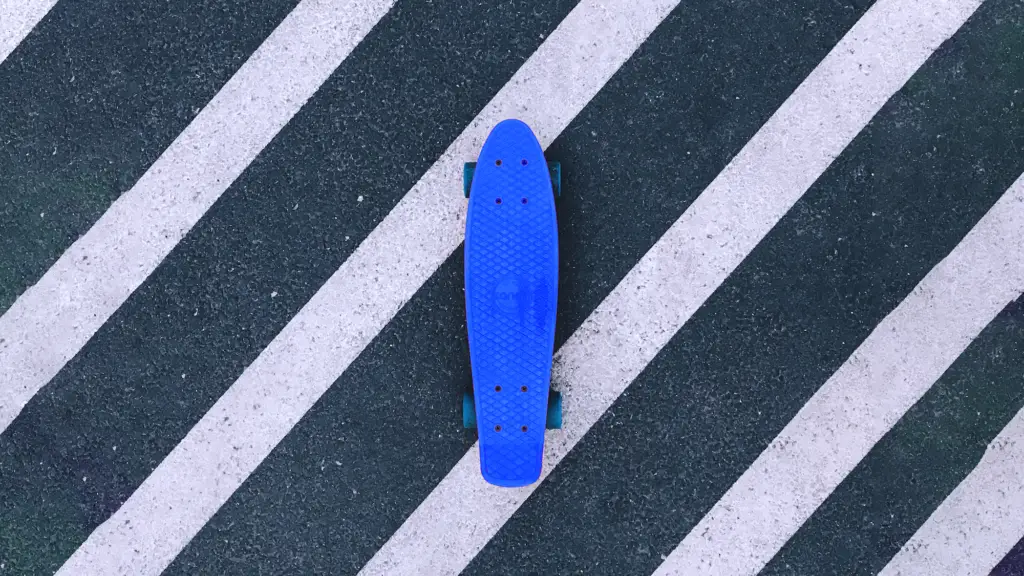 a blue skateboard laying on the ground