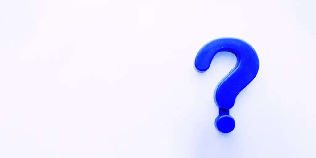 Blue question mark on a white background.