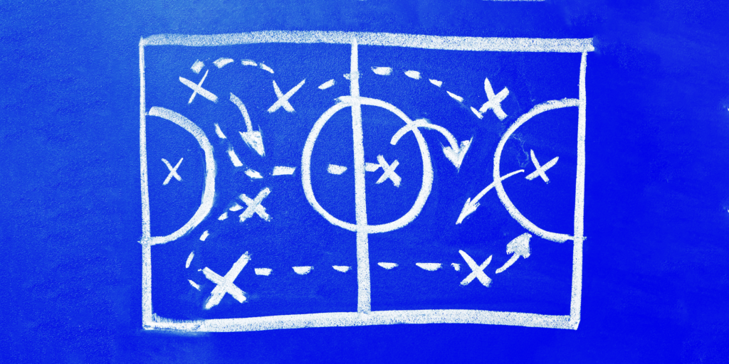soccer strategy drawn on a blue board