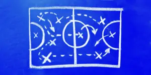 soccer strategy drawn on a blue board